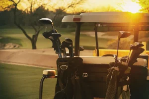 Discount Golfwagen bij zonsondergang fotobehang Sport