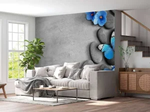 Clearance Grijze stenen met een blauwe vlinder en bloemen fotobehang Oppervlakten | Bloemen