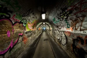 Outlet Lange ondergrondse tunnel met graffiti op de muren fotobehang Kunst & Design | 3d