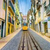 Best Tram door een straatje in Lissabon fotobehang Transport | Architectuur
