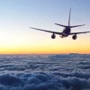 Sale Vliegtuig in de avond boven de wolken fotobehang Transport