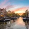 Outlet Zonsondergang in Amsterdam fotobehang Steden | Architectuur